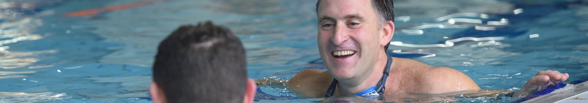 Two men talking in pool